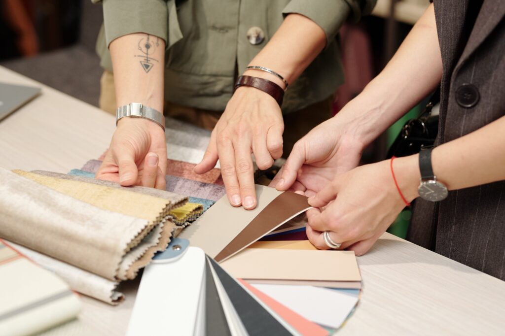 Hands of young manager of studio of interior design consulting customer