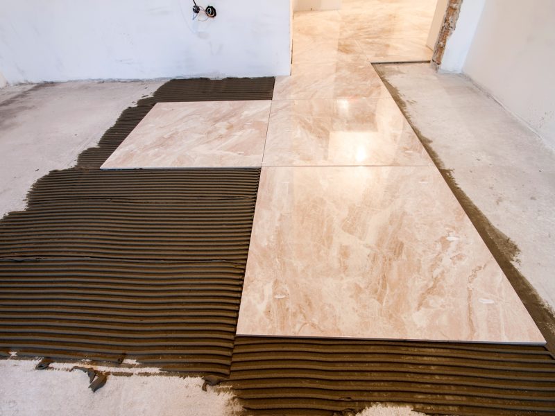 Ceramic tiles. Floor tiles installation. Home improvement, renovation - ceramic tile floor